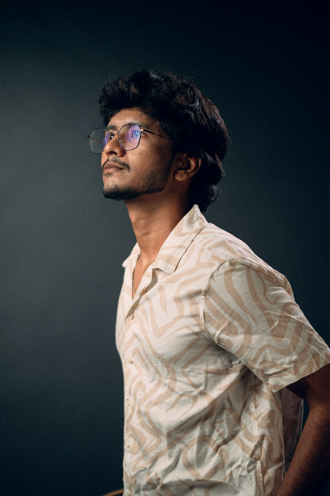 Studio portrait of a smiling man in glasses and a shirt